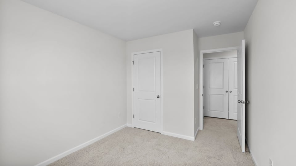 Bedroom with carpet and window.