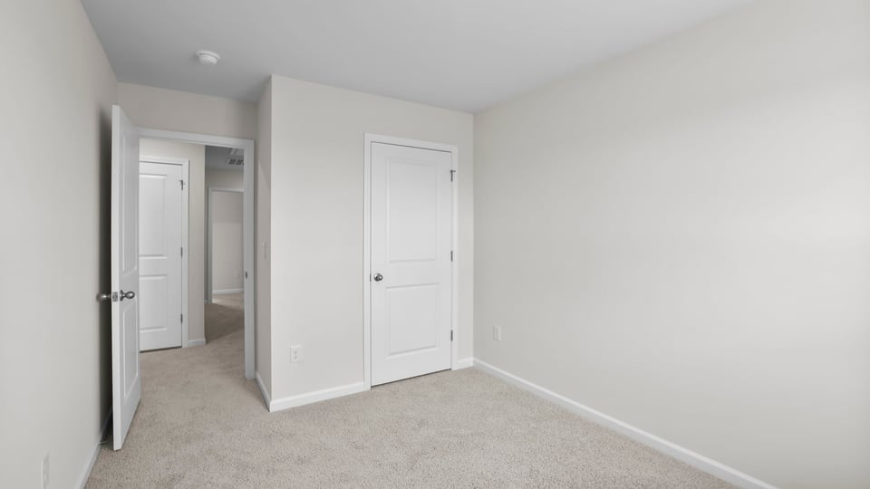 Bedroom with carpet and window.