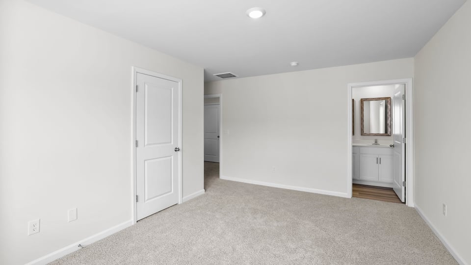 Bedroom with carpet and window.