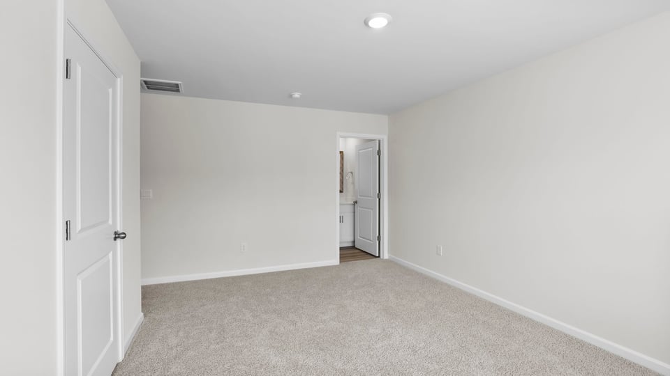 Bedroom with carpet and window.