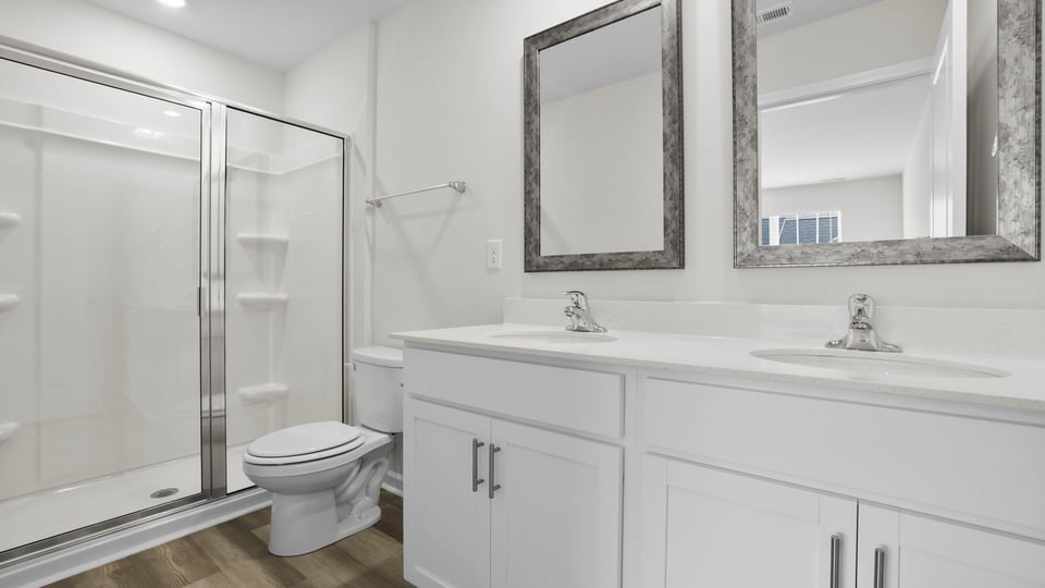 Bathroom with double vanity and shower.