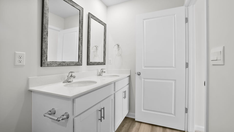 Bathroom with double vanity and shower.