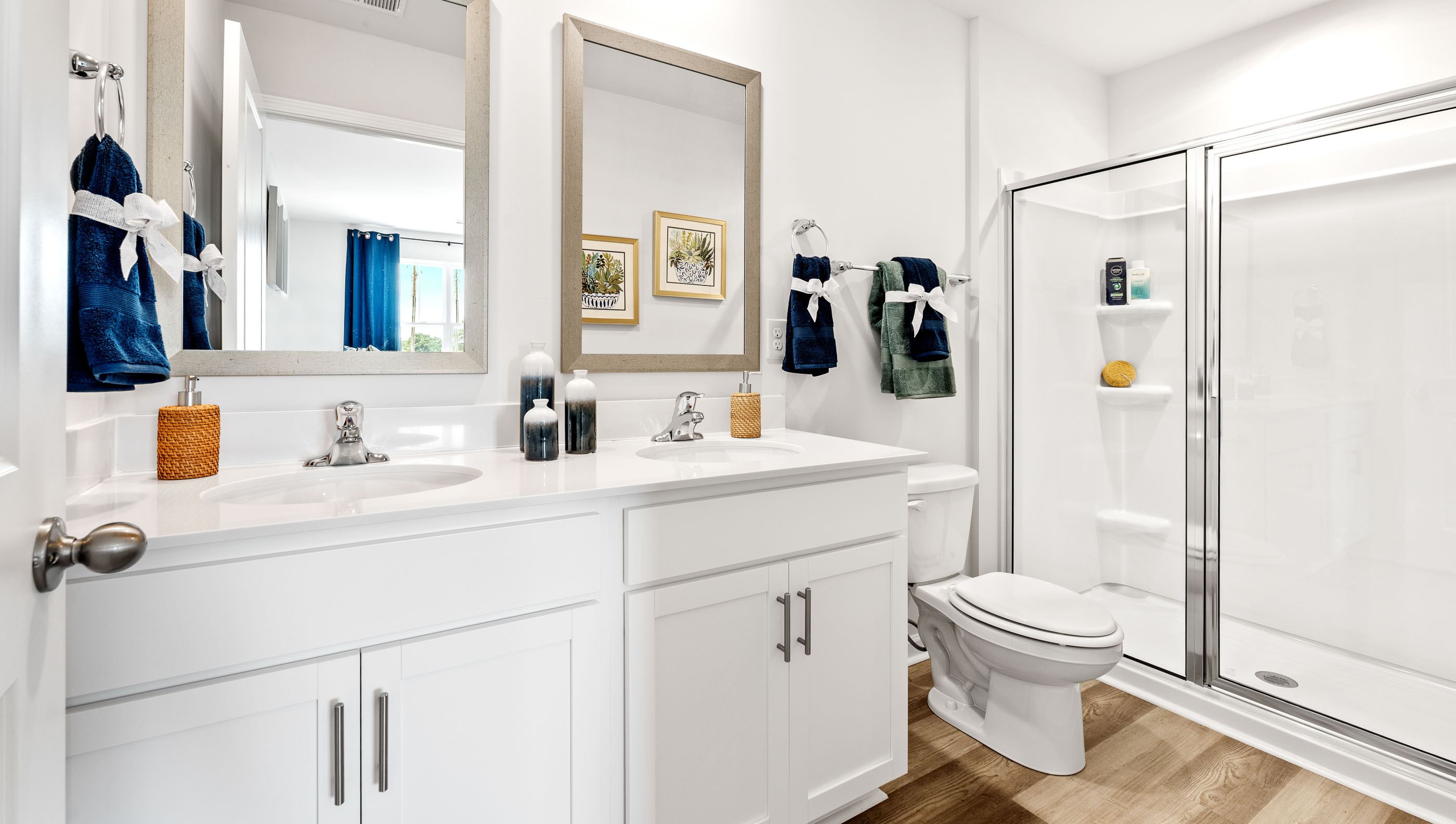 Bathroom with dual vanity and walk in shower.
