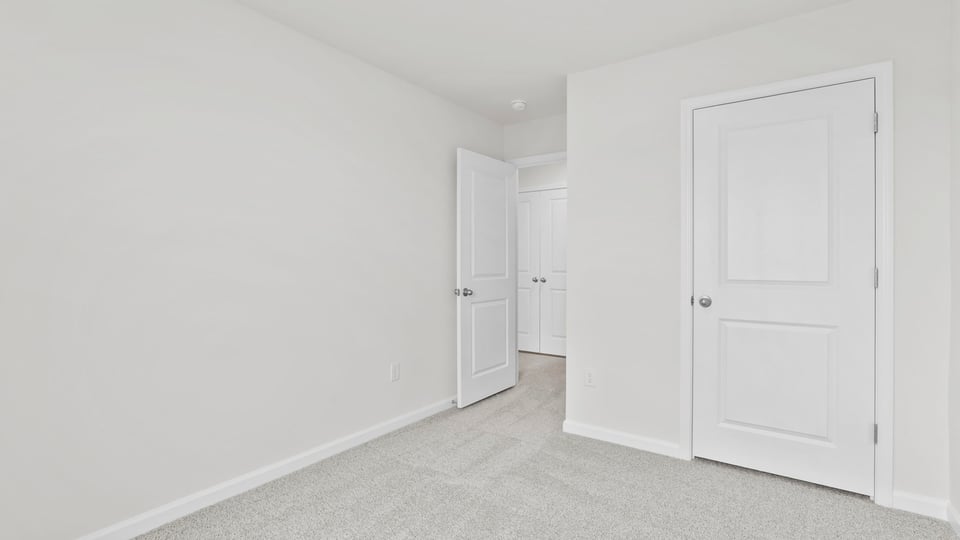 Bedroom with carpet and window.