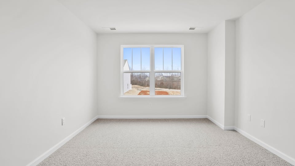 Bedroom with carpet and window.