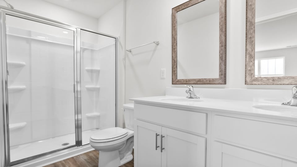 Bathroom with vanity and walj in shower.