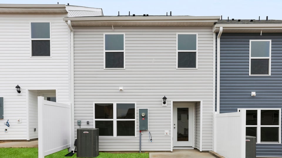 Exterior of home with large backyard.