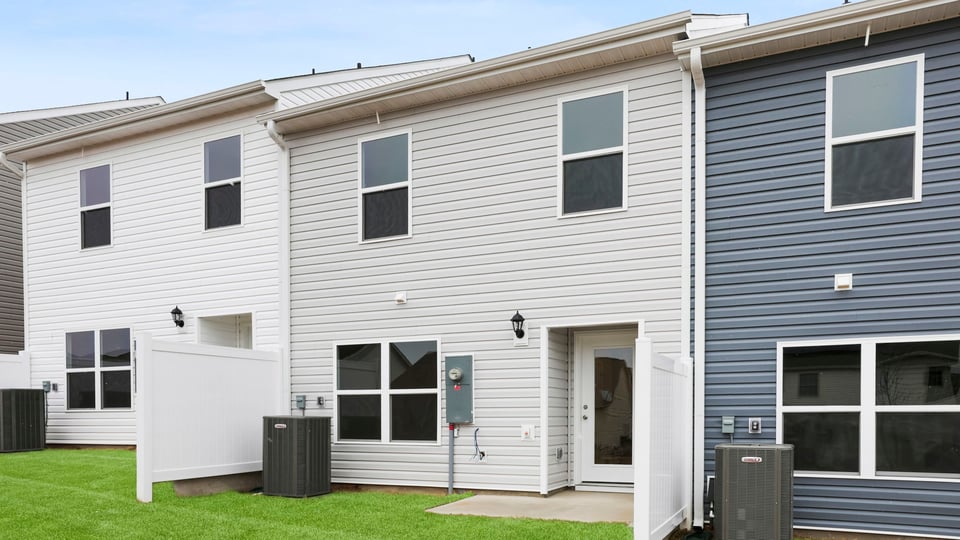 Exterior of home with large backyard.