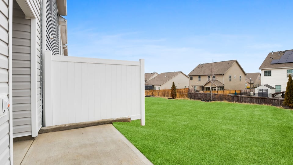 Exterior of home with large backyard.