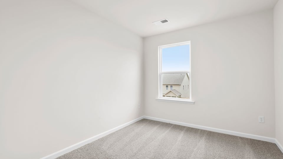 Bedroom with carpet and window.