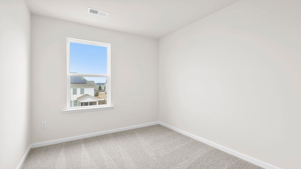 Bedroom with carpet and window.