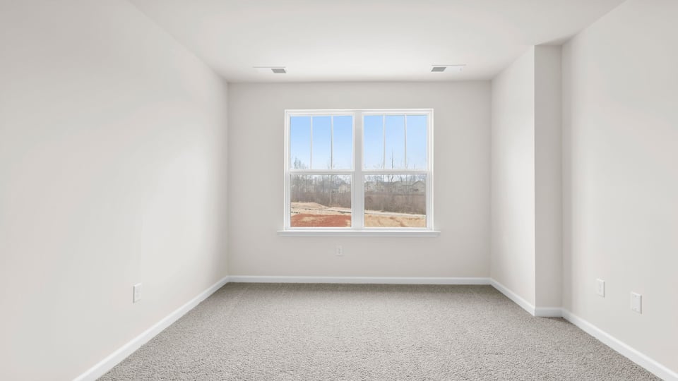 Bedroom with carpet and window.