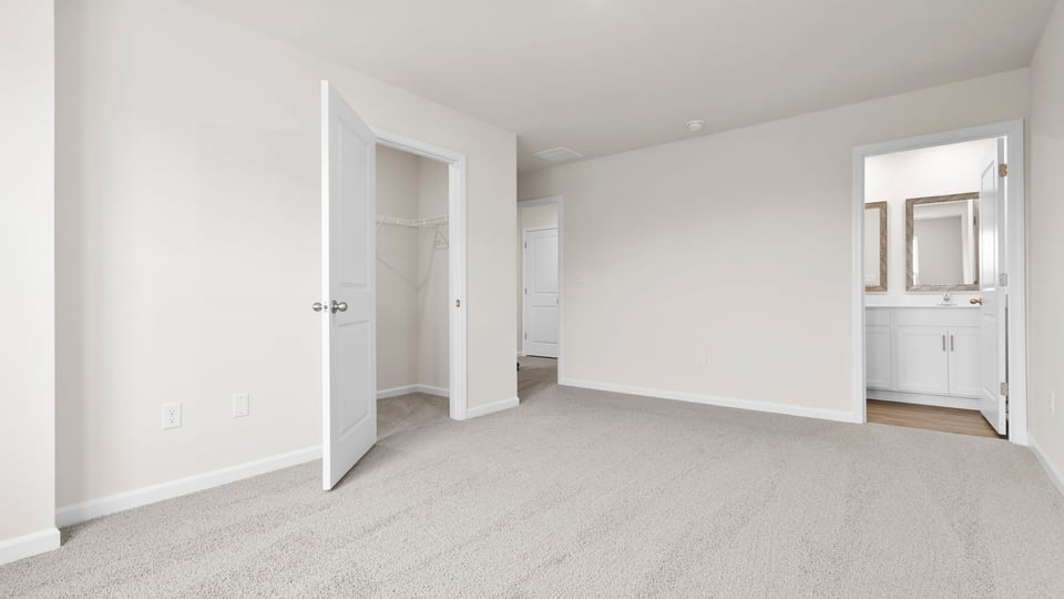 Bedroom with carpet and window.