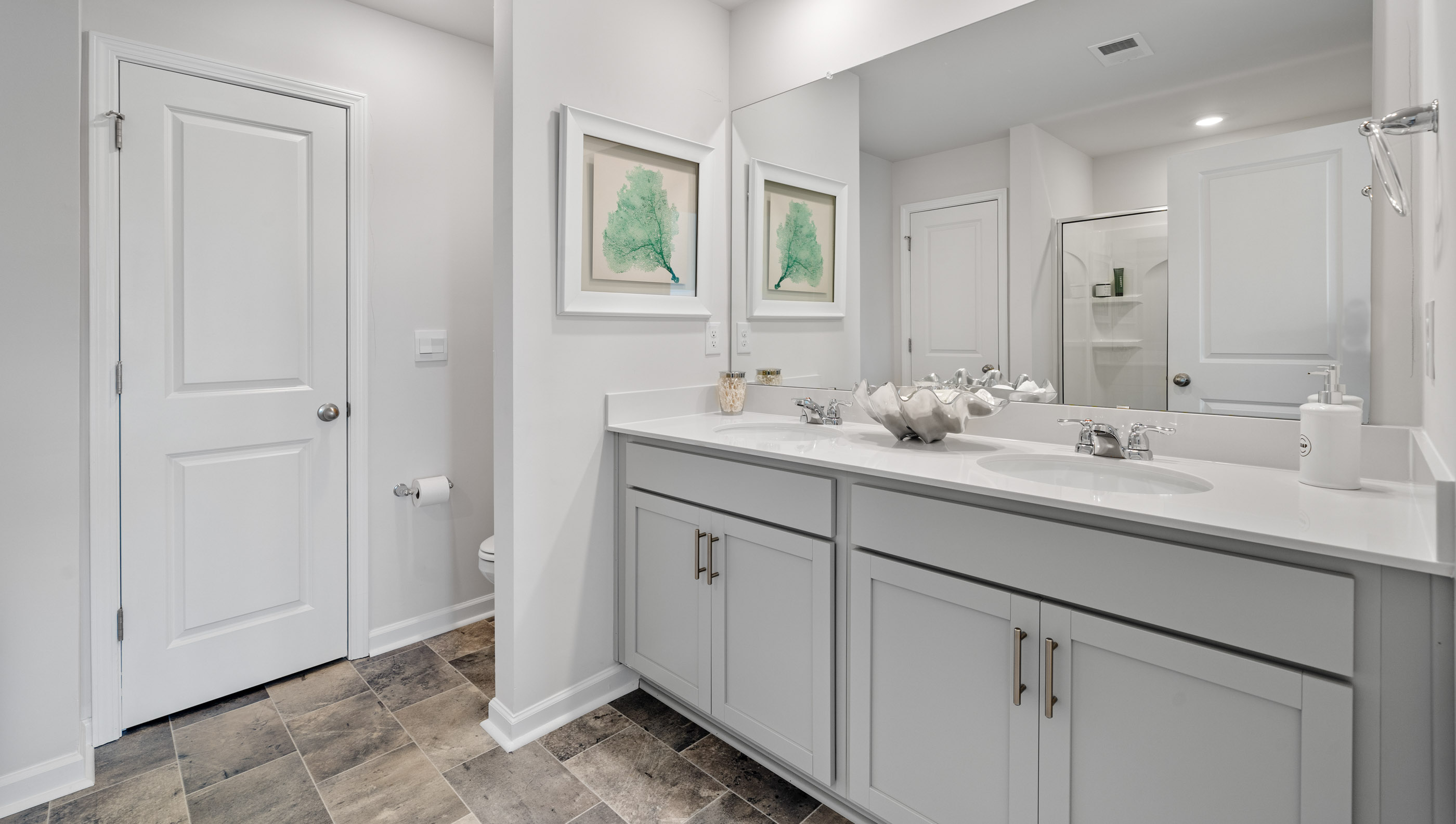Primary bathroom with double vanity sink.