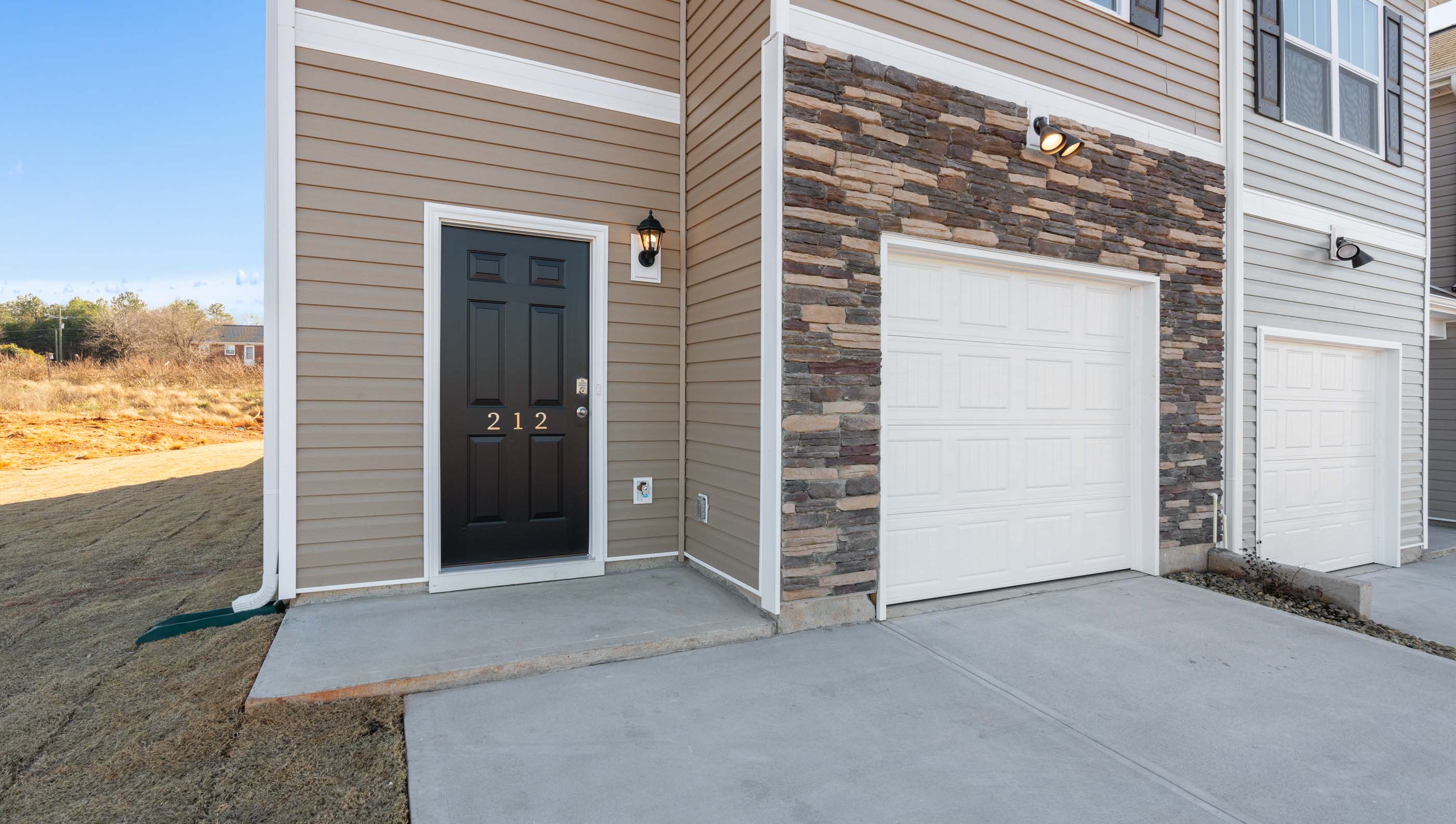 Front exterior of Maywood with 2 car garage.