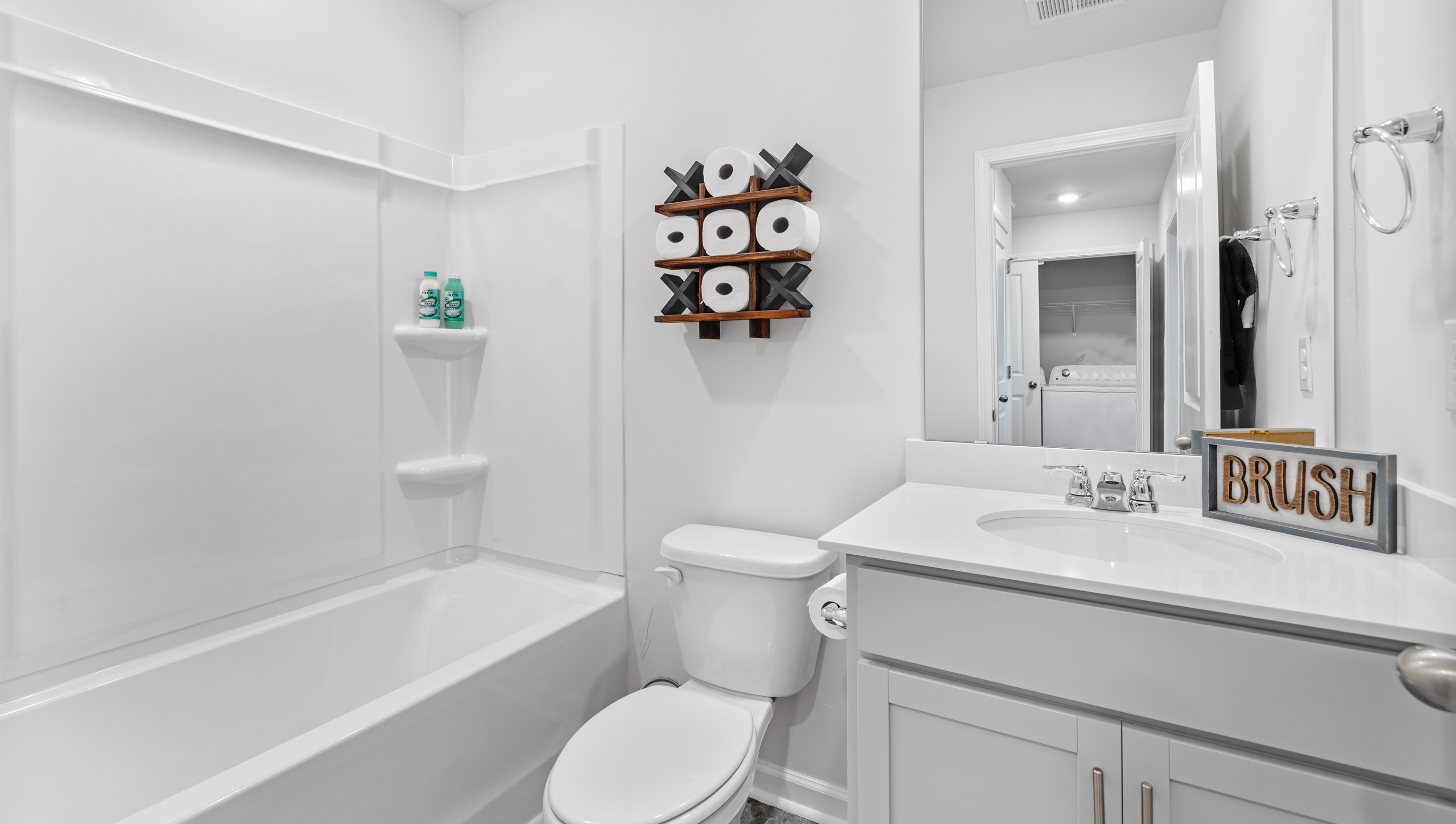 Bathroom with single vanity sink and bathtun.