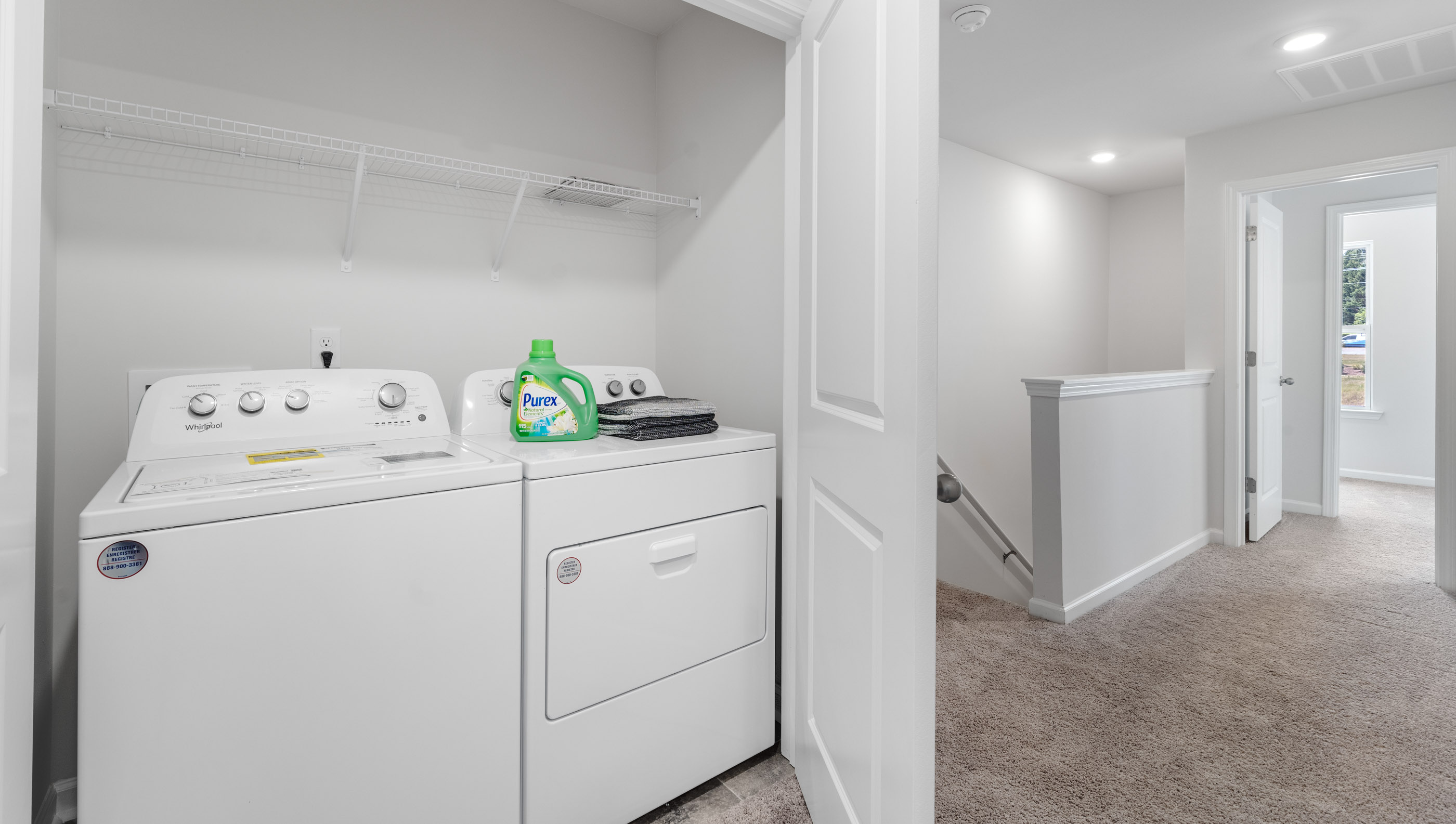Laundry room with hanging shelves.