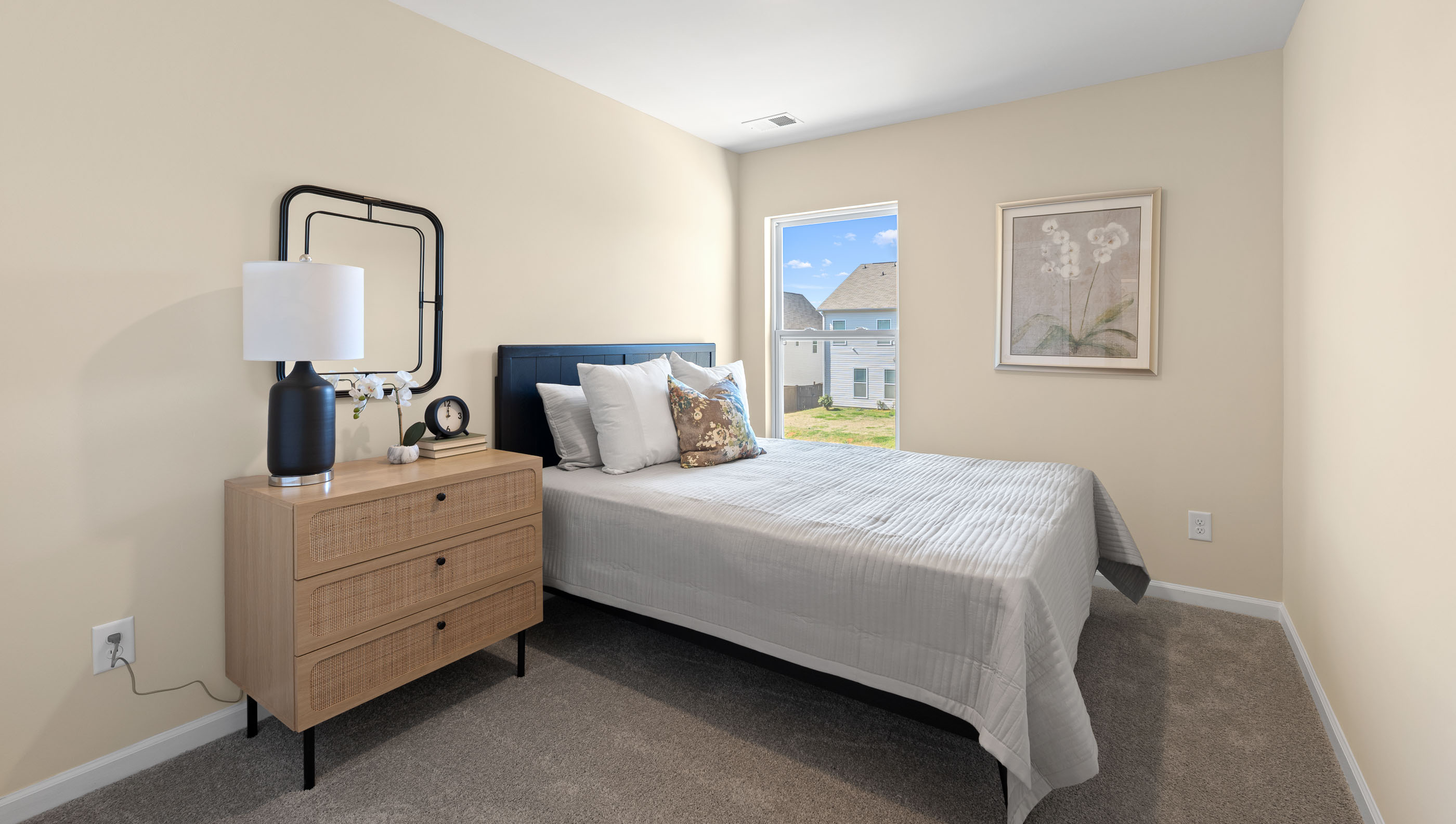 Bedroom with carpet and window.