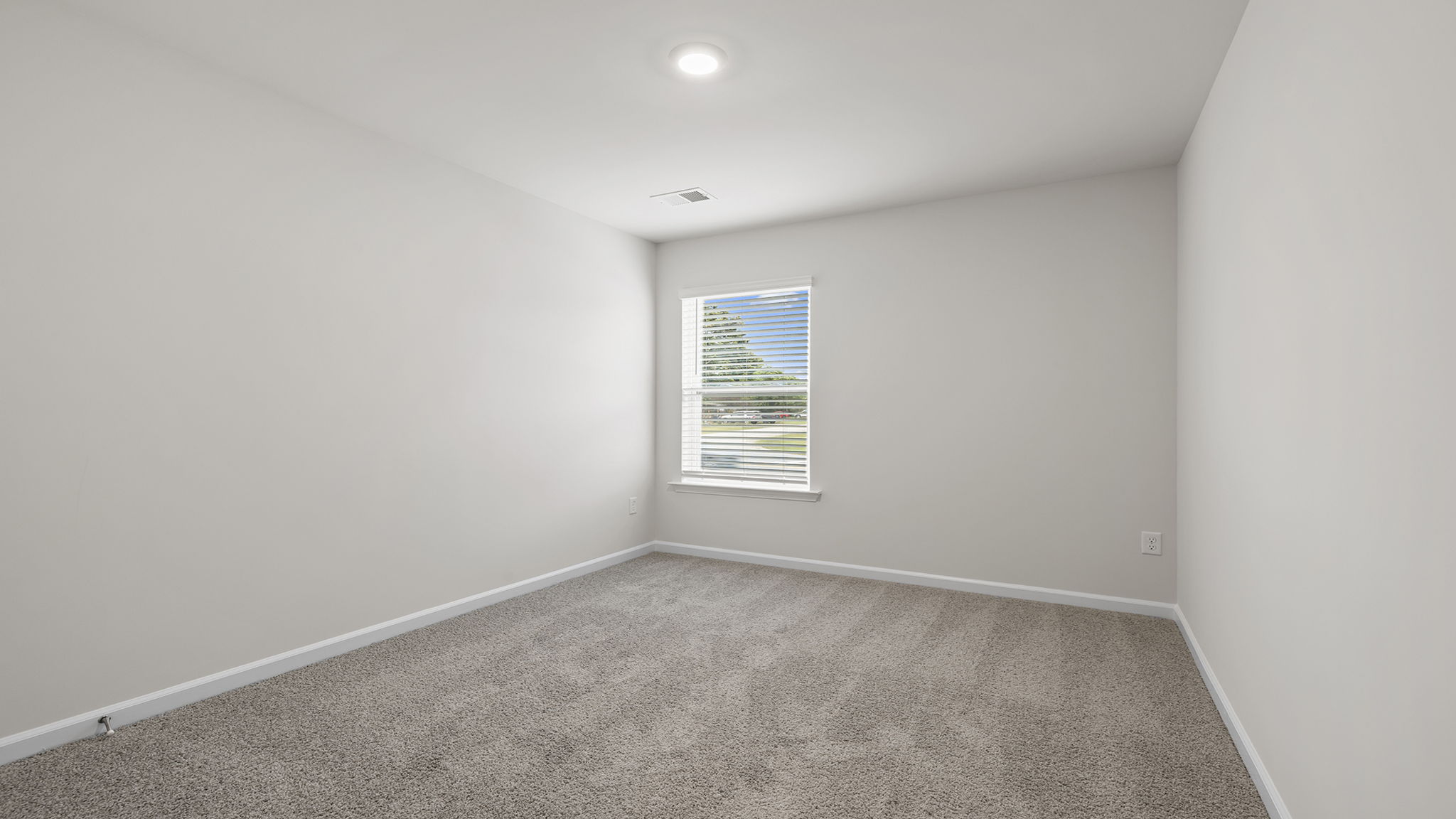 Bedroom with carpet and window.