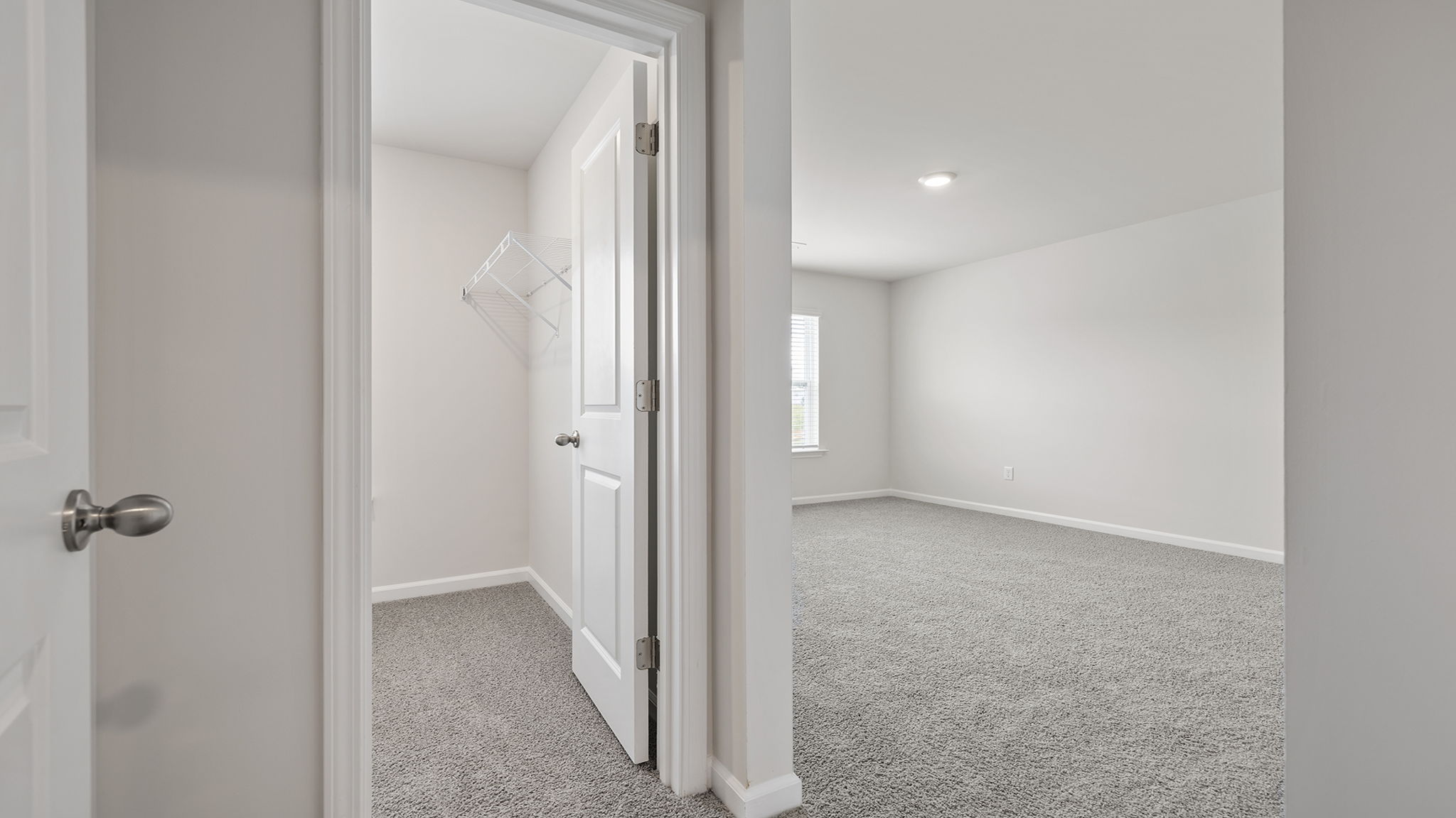 Bedroom with carpet with window.
