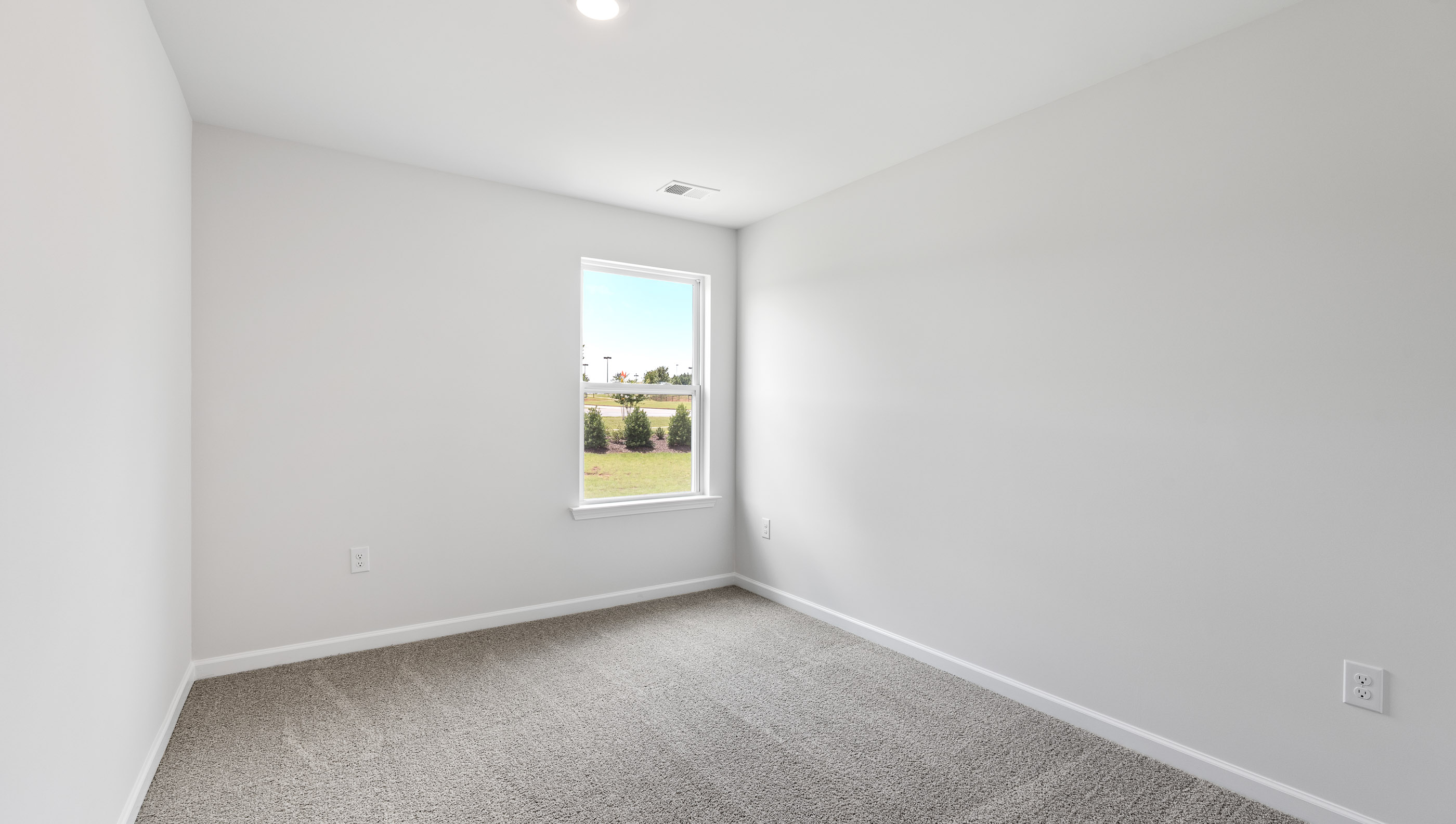 Bedroom with carpet and windows.
