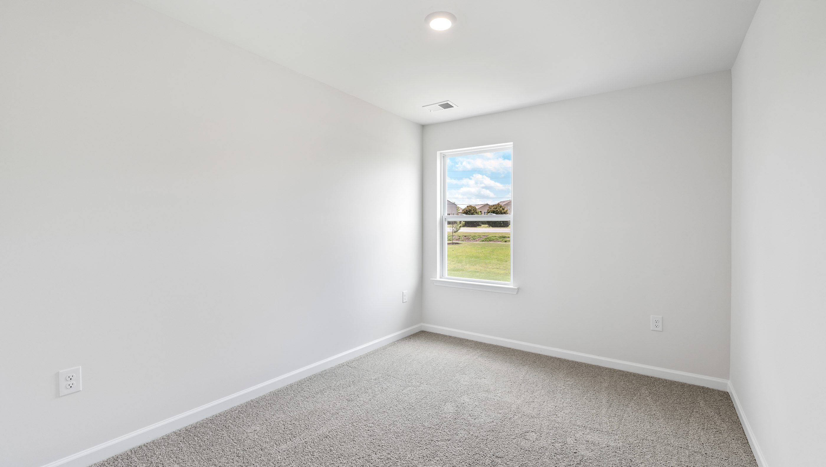 Bedroom with carpet and windows.