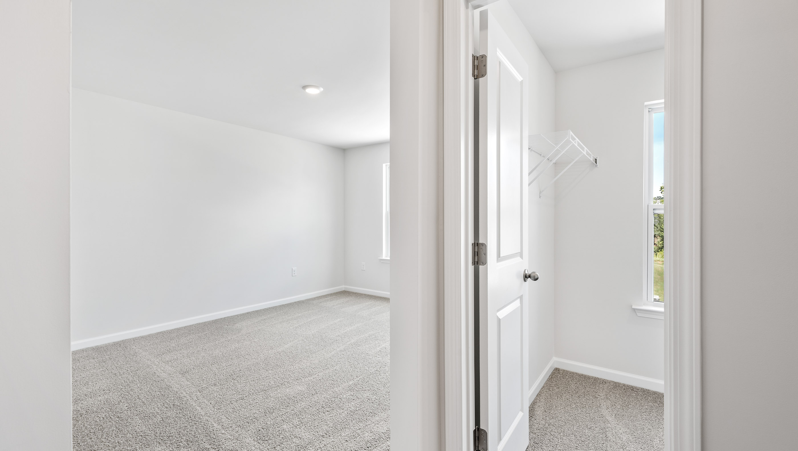Bedroom with carpet and windows.