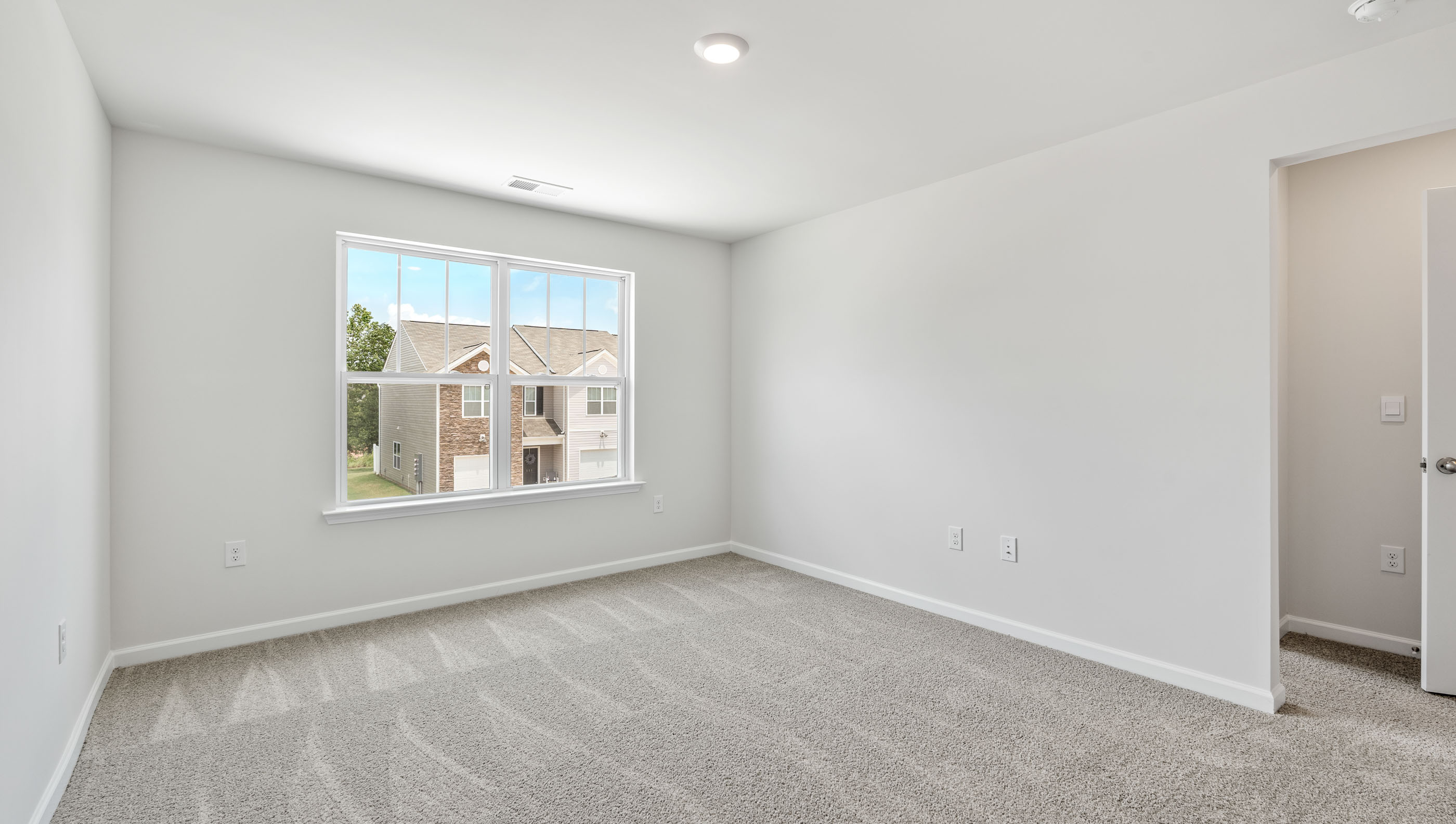 Bedroom with carpet and windows.