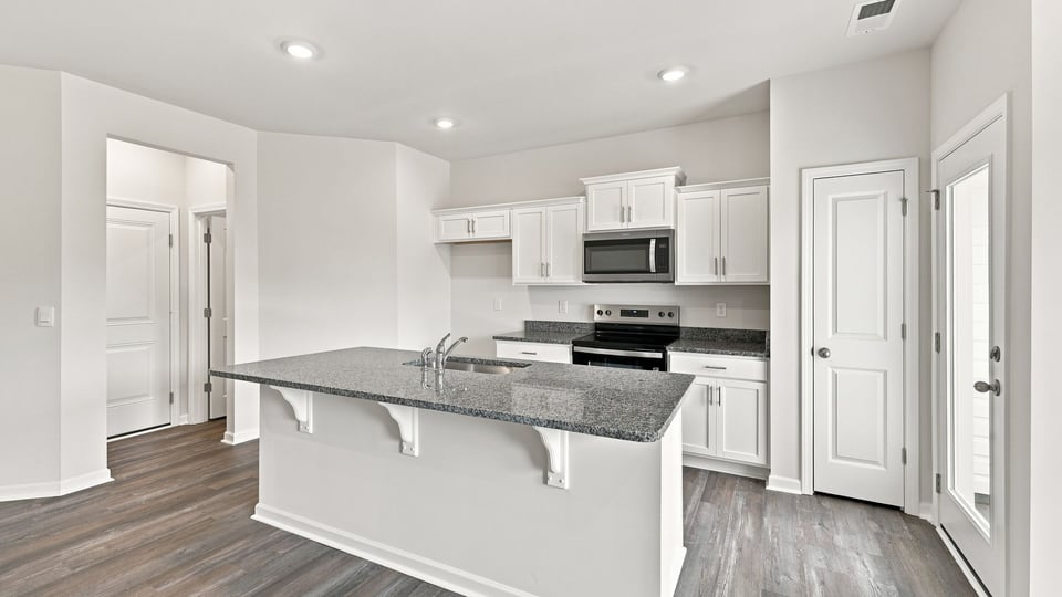 Kitchen with island and cabinets.
