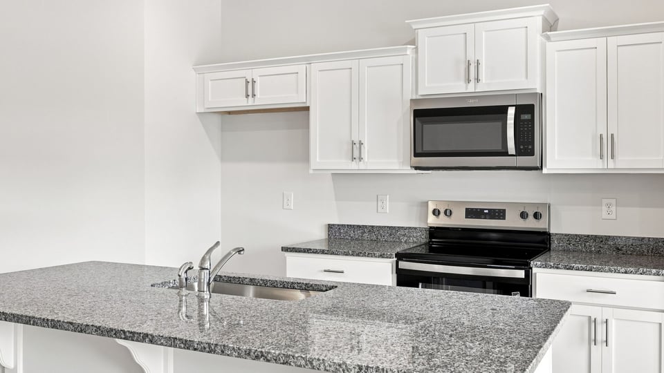 Kitchen with island and cabinets.