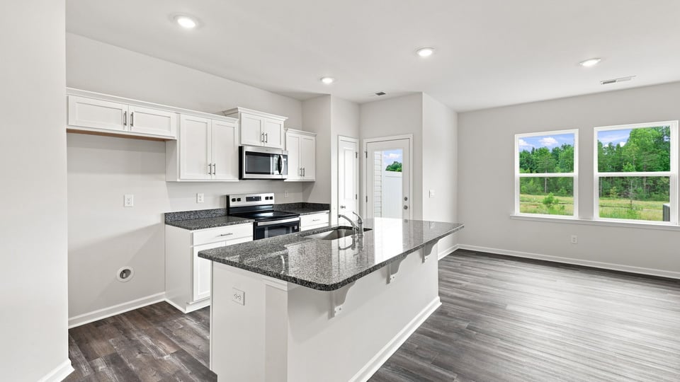 Kitchen with island and cabinets.