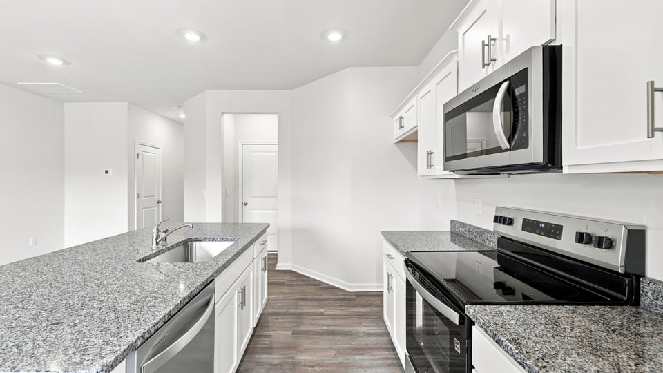 Kitchen with island and cabinets.