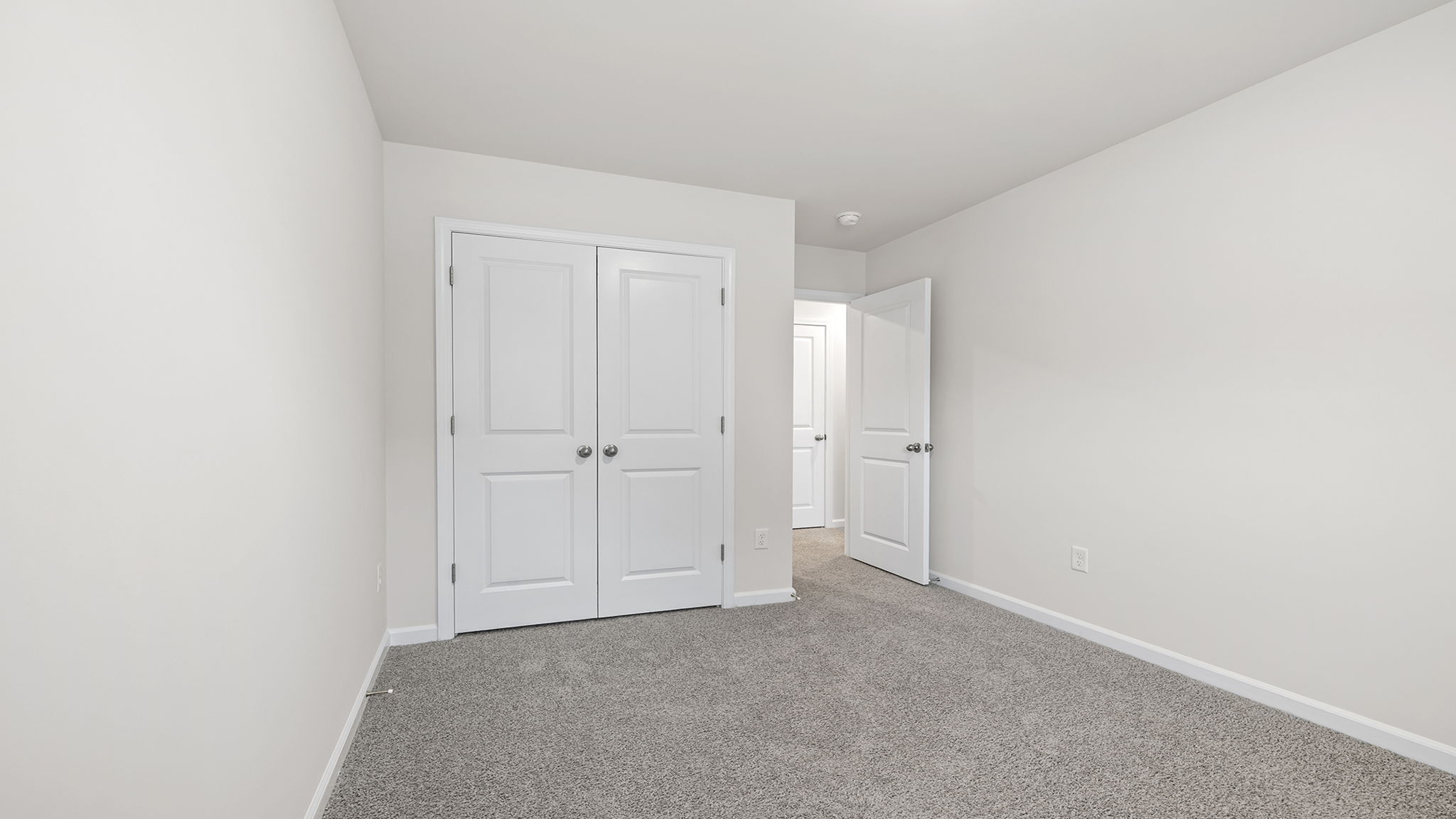 Bedroom with carpet and windows.