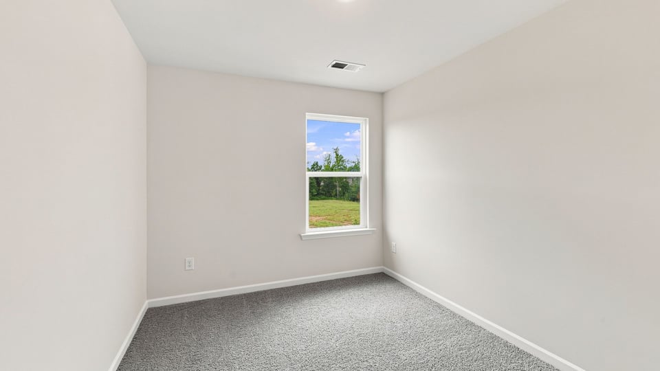 Bedroom with carpet and windows.