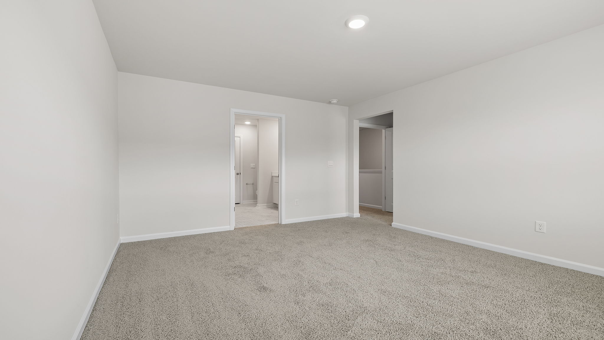Bedroom with carpet and windows.
