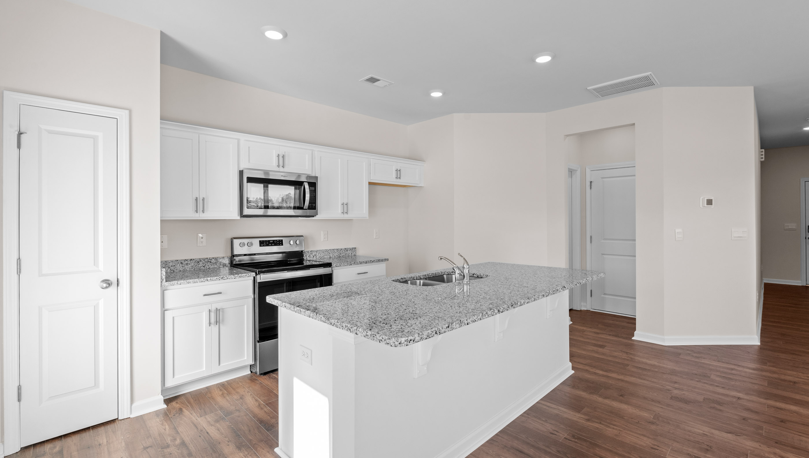 Kitchen with island and granite countertops.