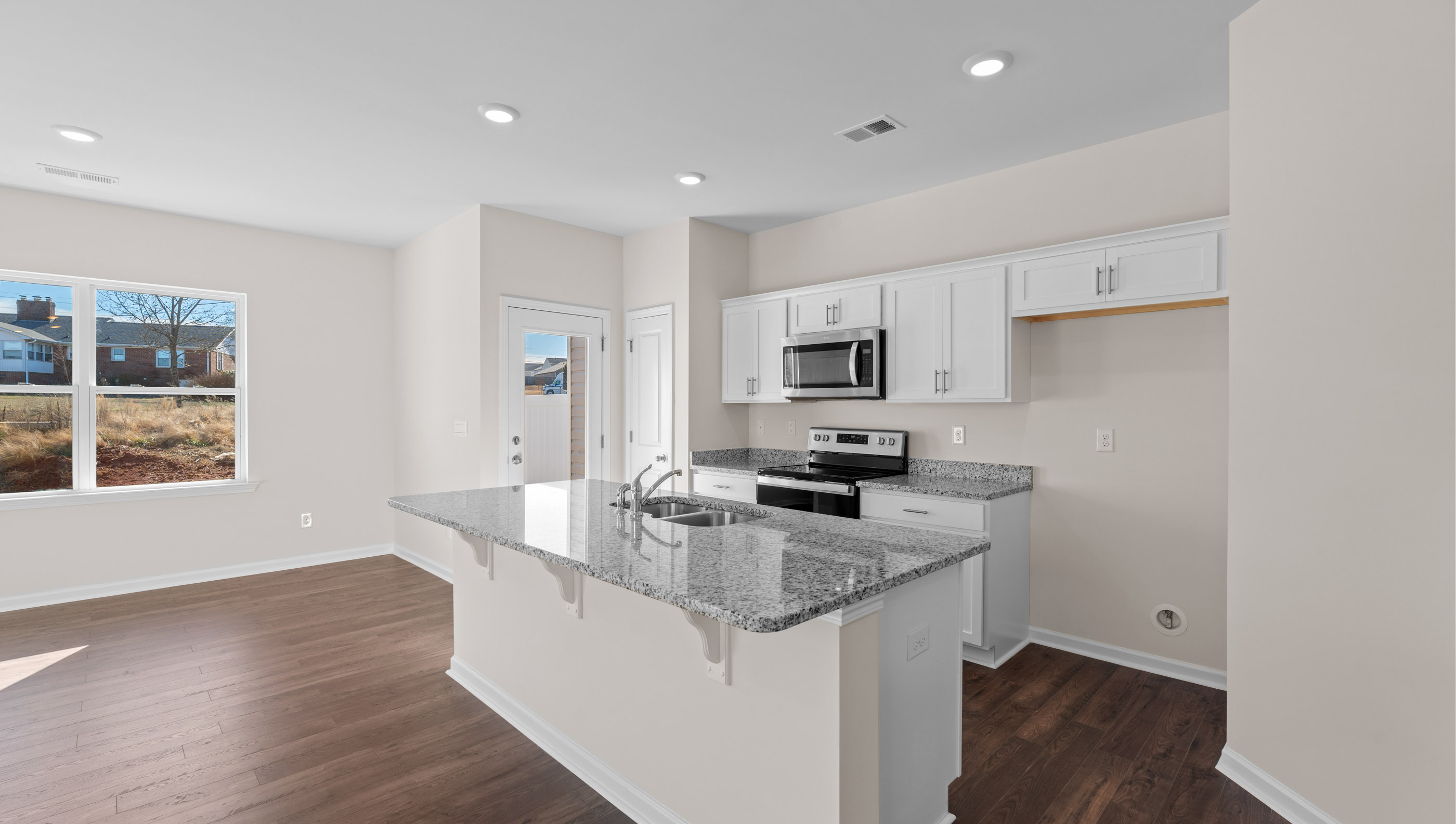 Kitchen with island and granite countertops.