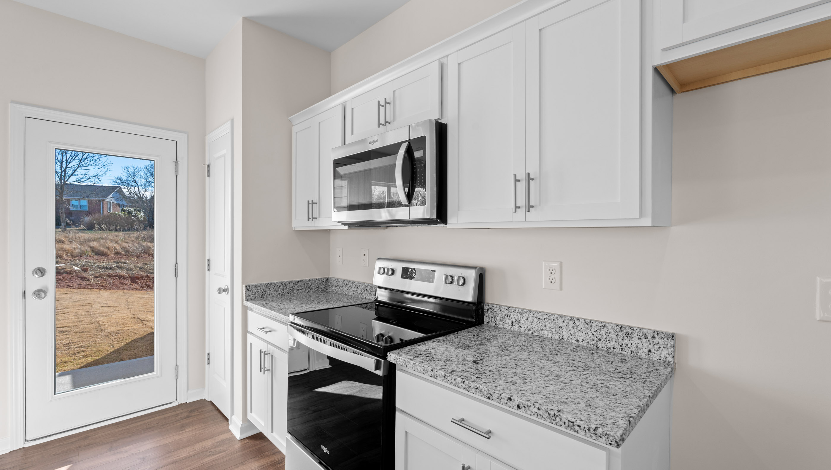 Kitchen with granite countertops and stainless steel appliances.
