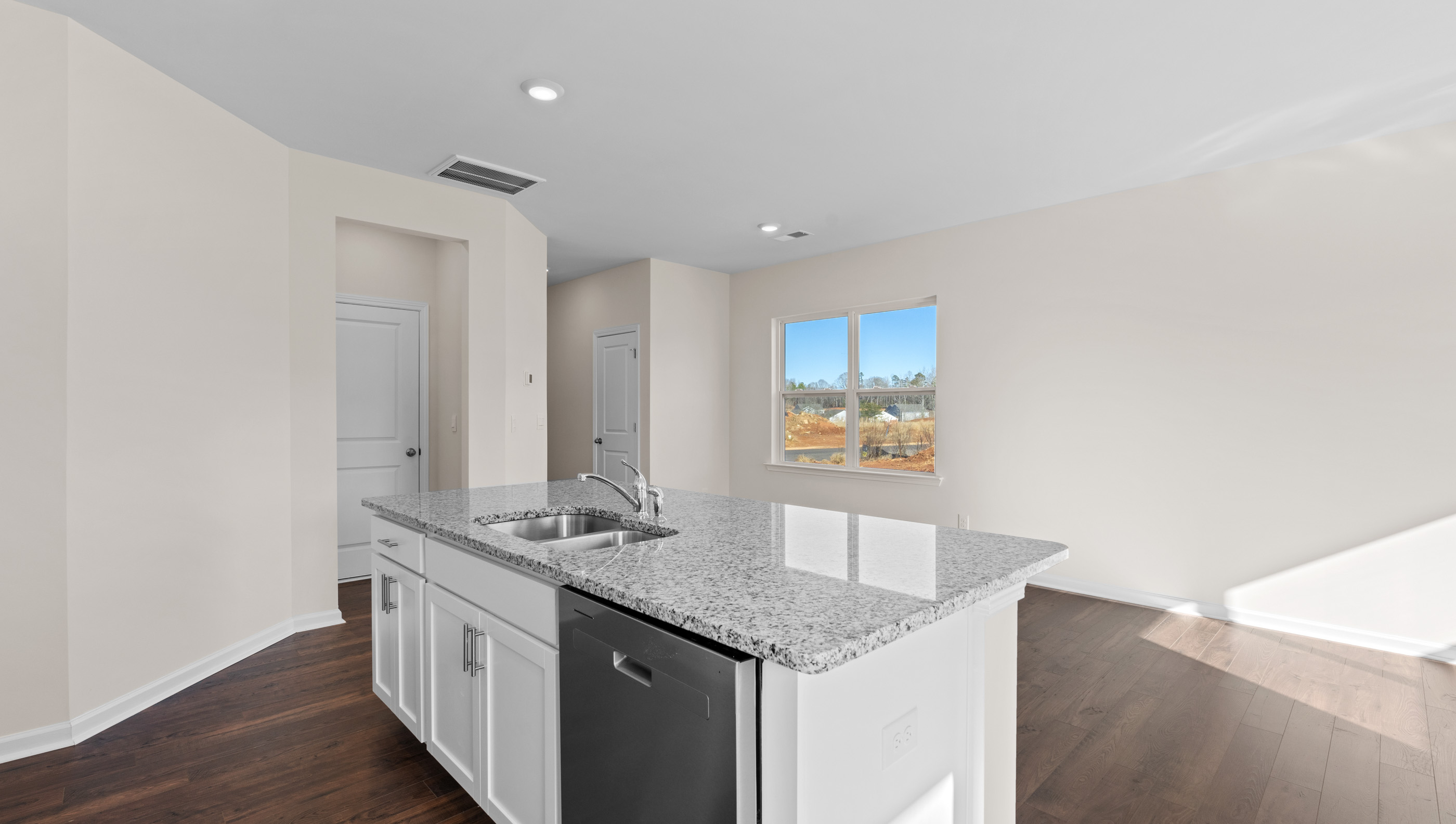 Kitchen with island and granite countertops.