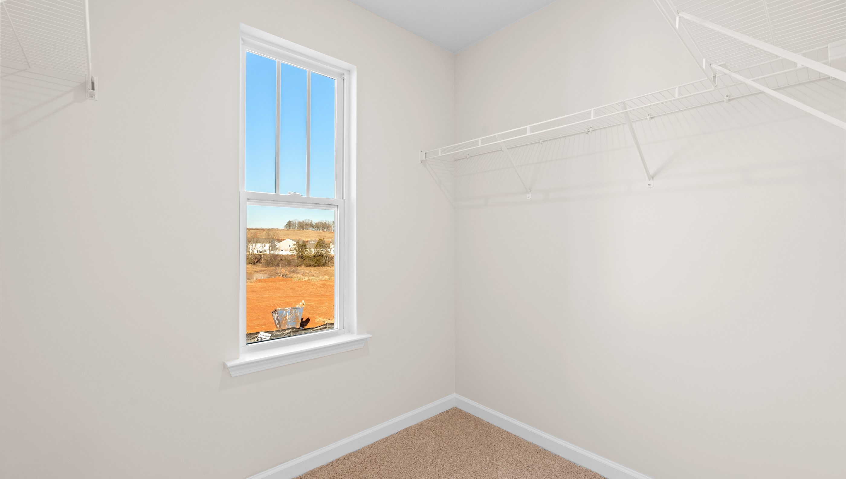Walk in closet with shelves.
