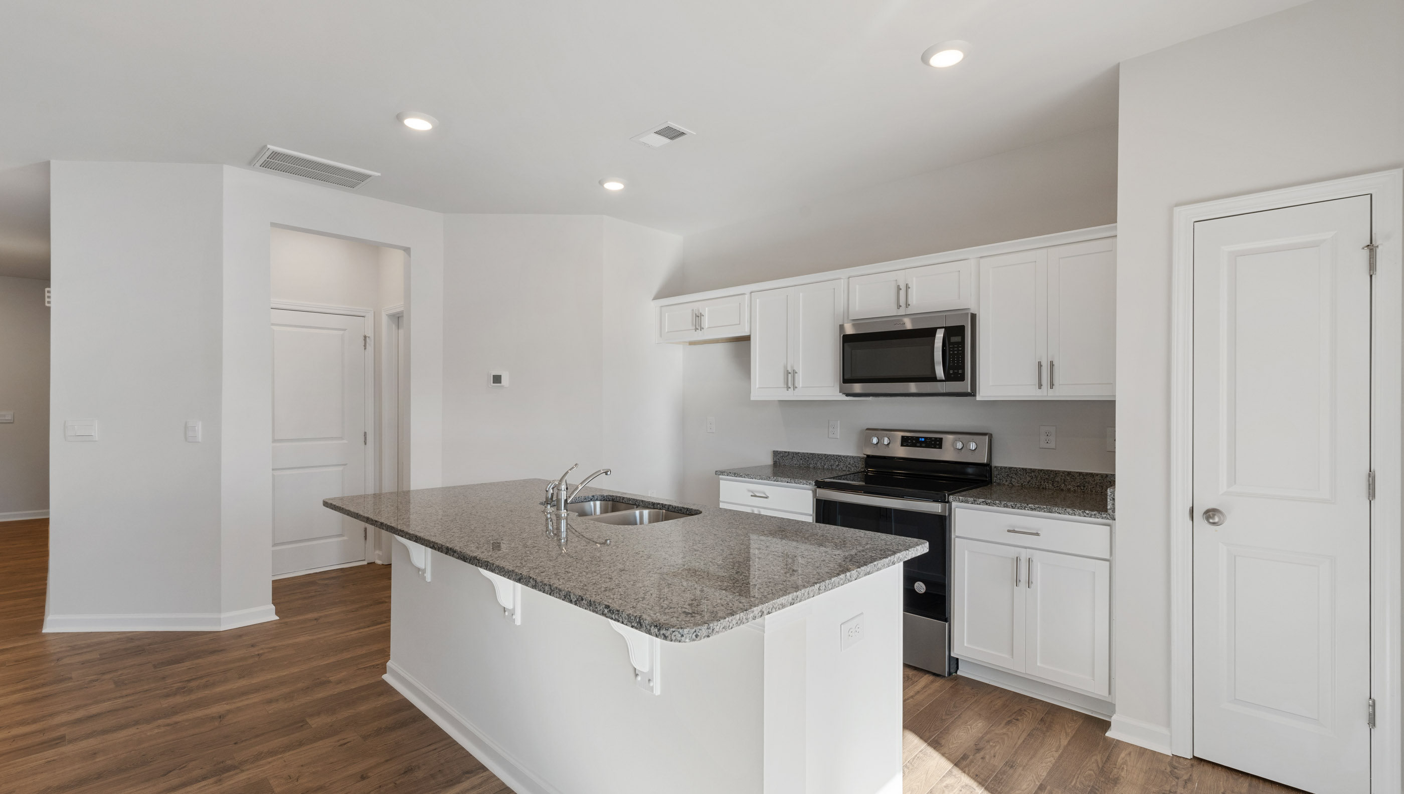 Kitchen and island with granite countertops.