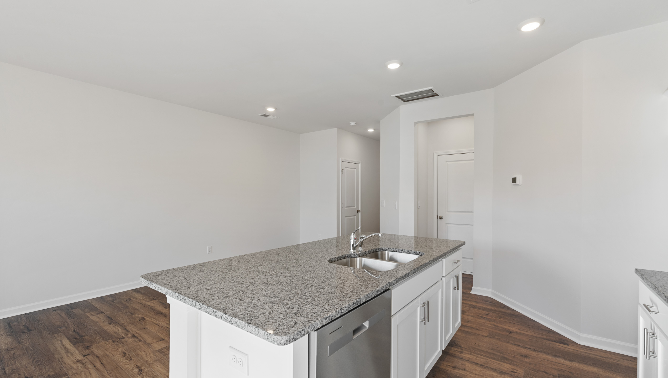 Kitchen and island with granite countertops.