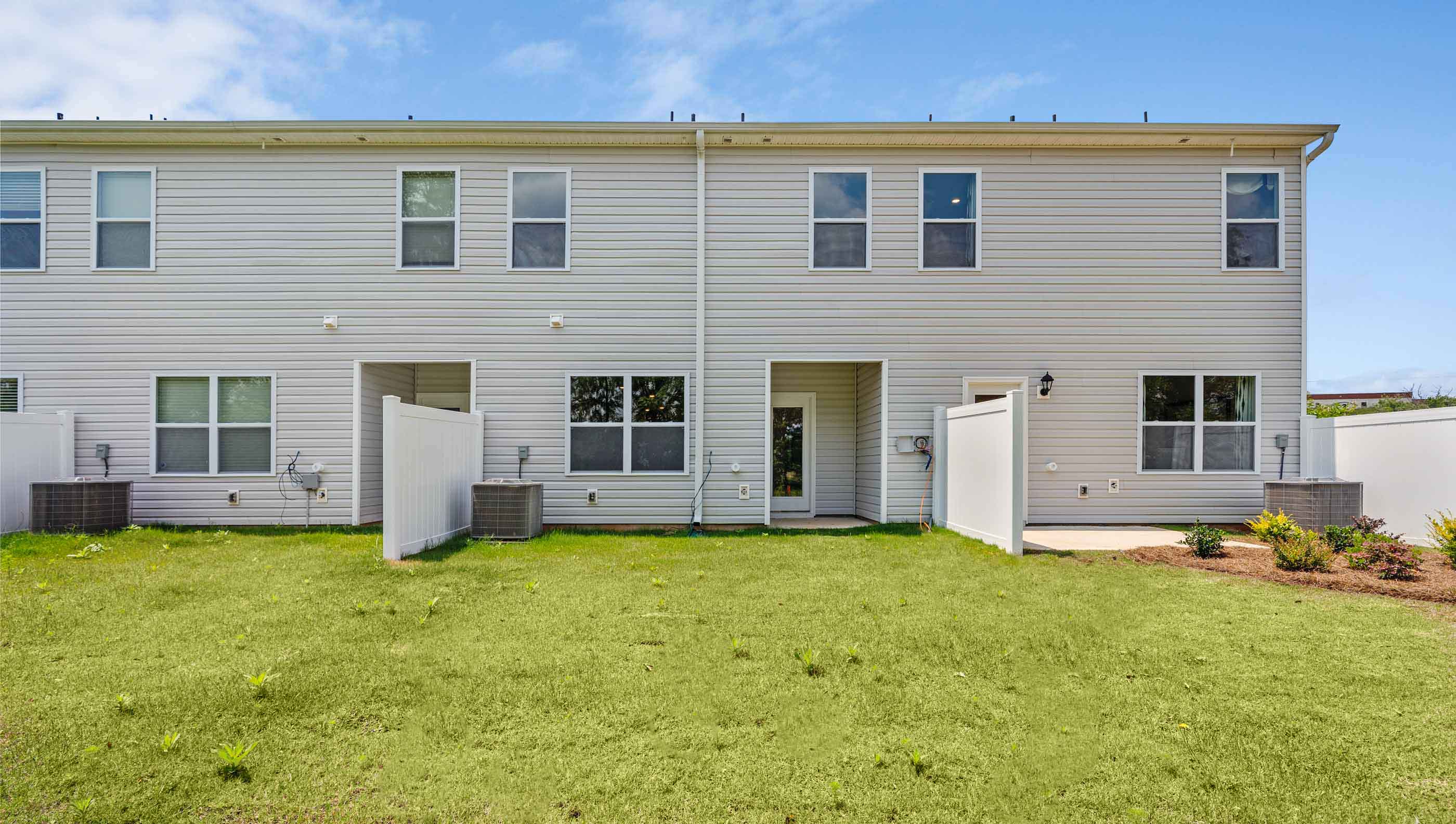 Exterior of townhome with bakyard.