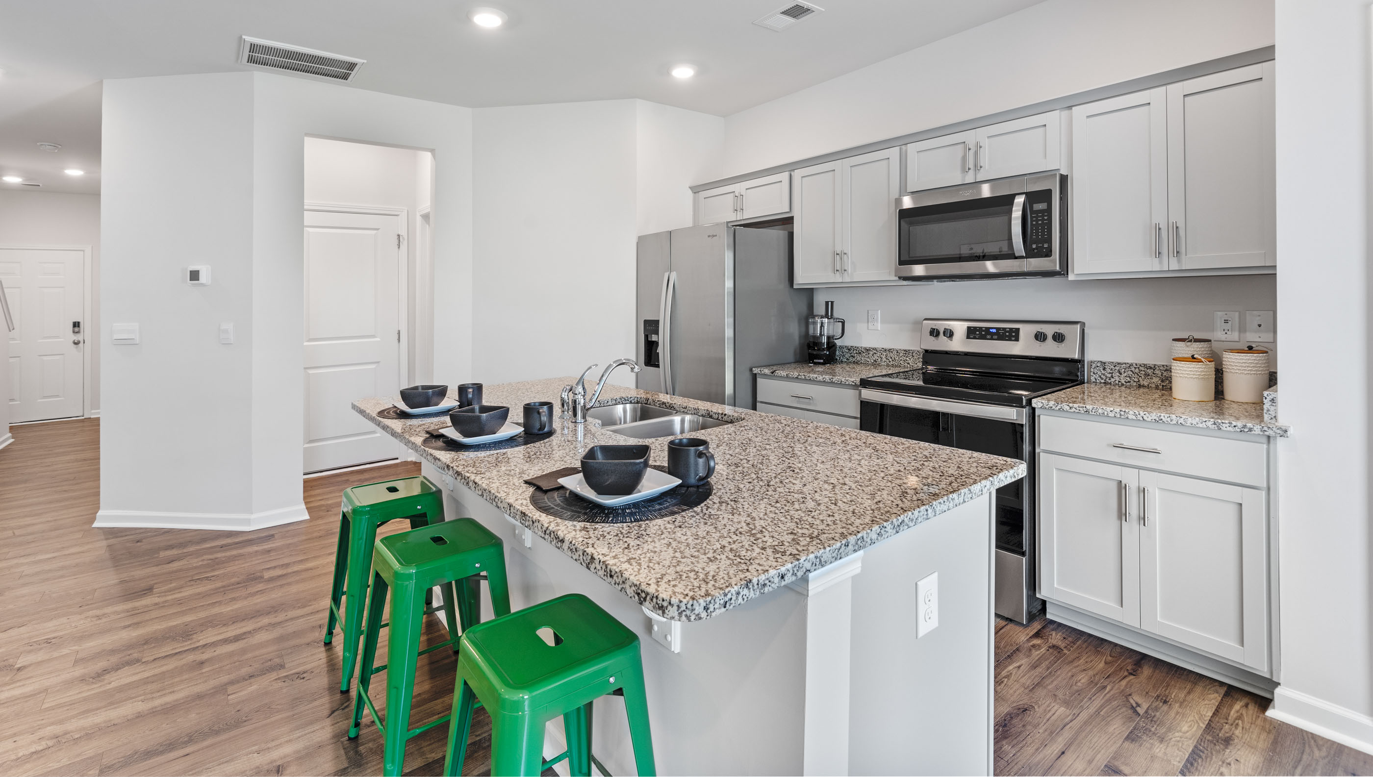 Kitchen and island with granite counter tops.