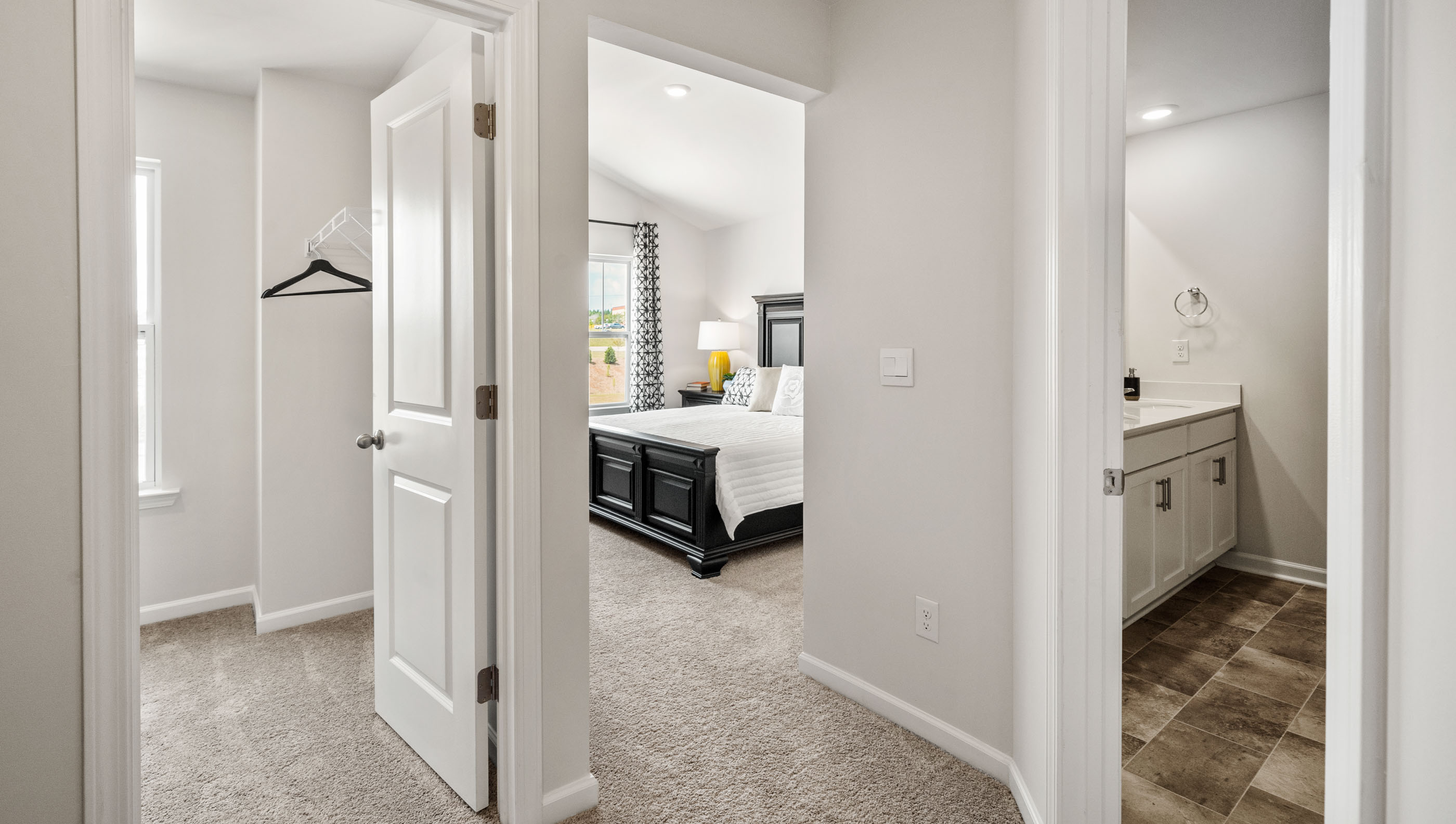 Hallway upstairs with carpet and view of rooms.
