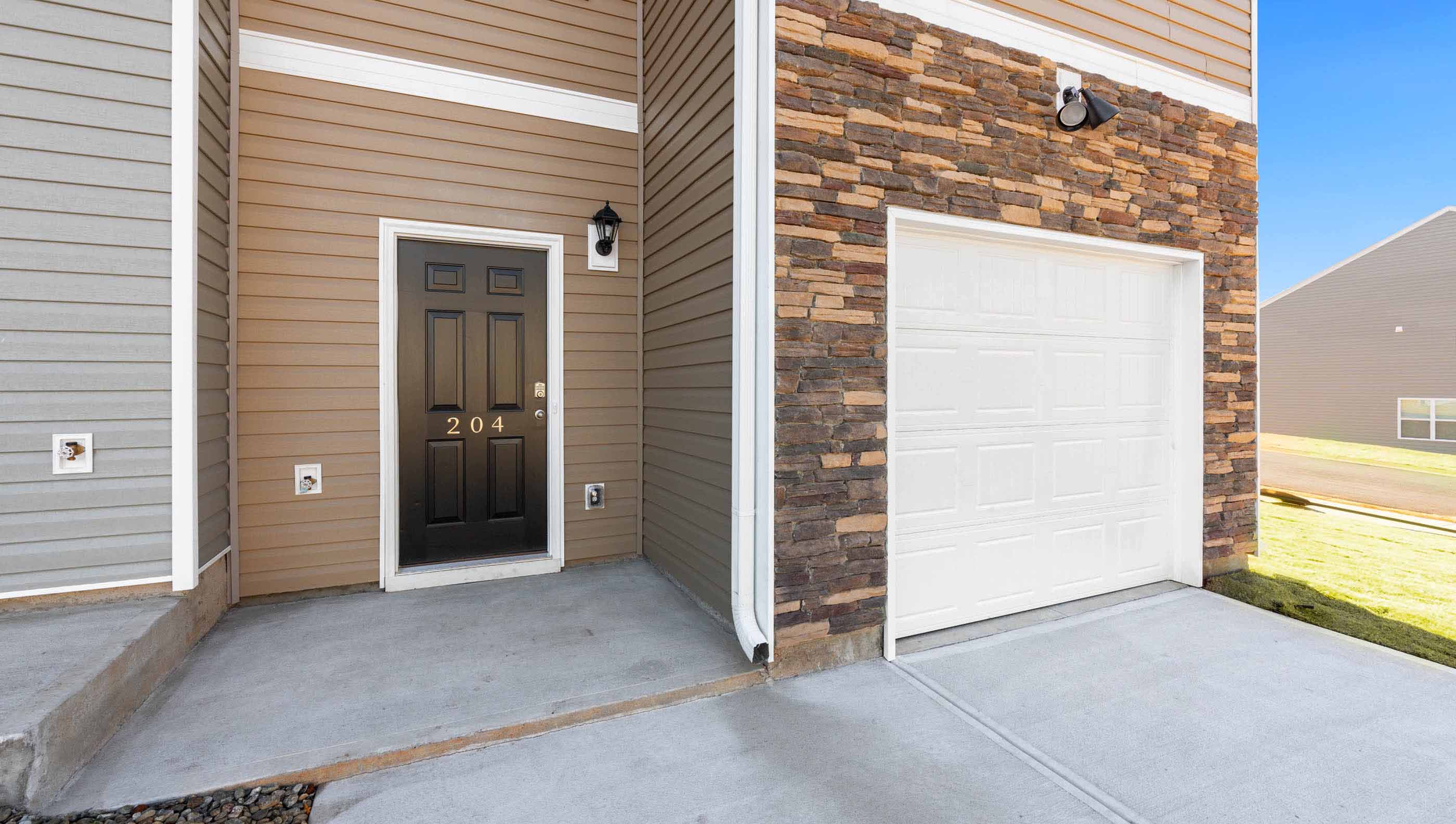 Front exterior of Newton with 2 car garage.