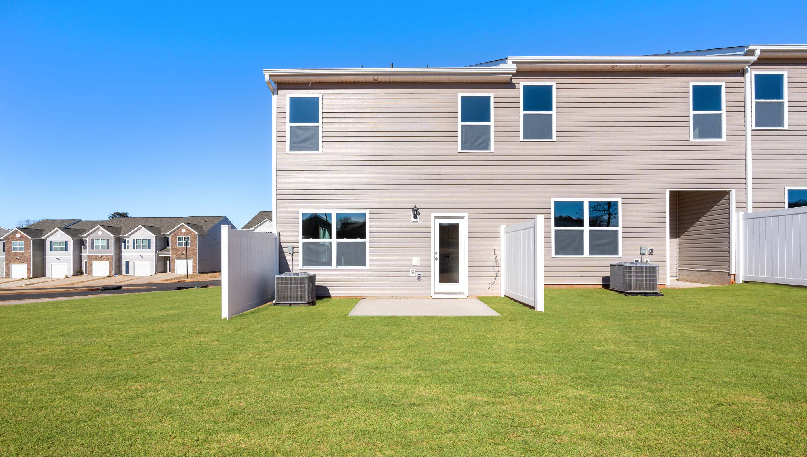 Back exterior of Newton with large backyard.