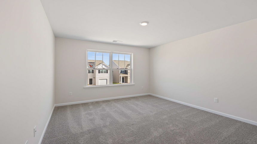 Bedroom with carpet and wiindow.