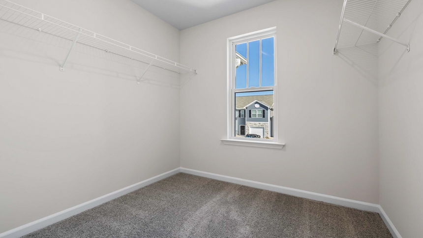 Bedroom with carpet and wiindow.