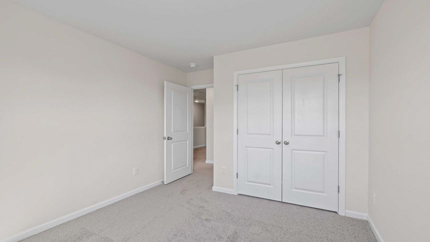Bedroom with carpet and windows.